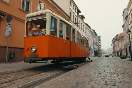 Vintage Tram on a Cobblestone Street