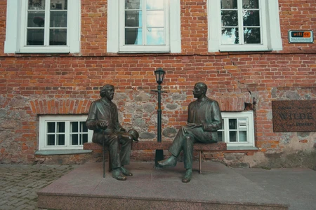 Bronze Sculptures on a Brick Wall