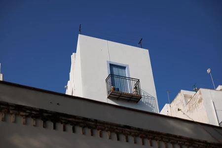 Sunlit Balcony on White Building