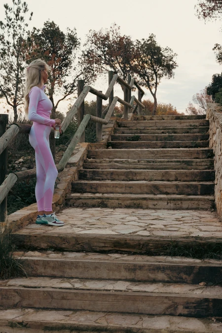Woman in Athletic Wear on Stone Steps