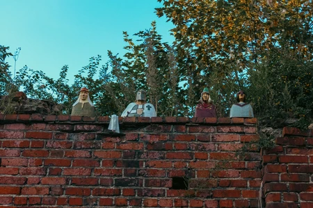 Medieval Figures on Brick Wall