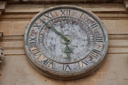 Ancient Clock on Stone Wall