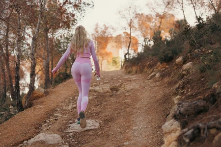 Woman Jogging on Forest Trail