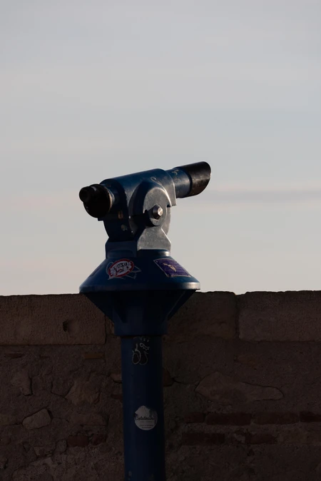 Public Telescope Overlooking a City