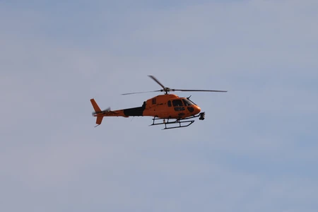Orange Helicopter in Flight