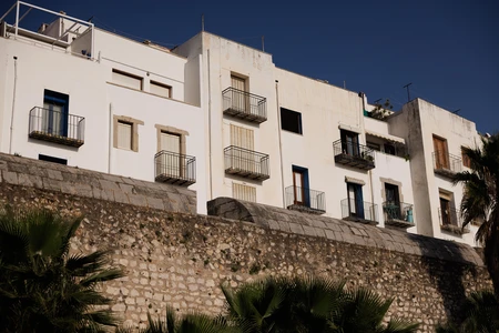 Mediterranean Building and Stone Wall