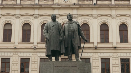 Statue in Front of Historical Building