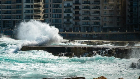 Waves Crashing Against Urban Coast