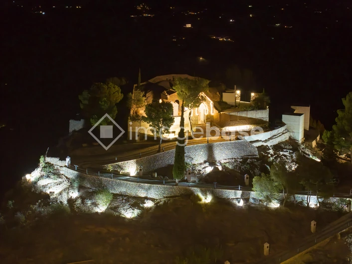 Illuminated Hilltop Structure at Night
