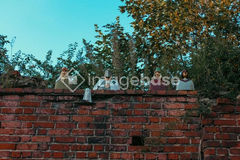 Medieval Figures on Brick Wall