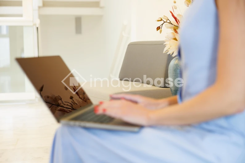 Woman Using Laptop in Minimalist Setting