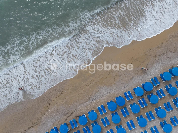 Coastal Relaxation with Blue Umbrellas