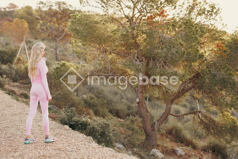 Woman in Pink Gym Wear in Nature