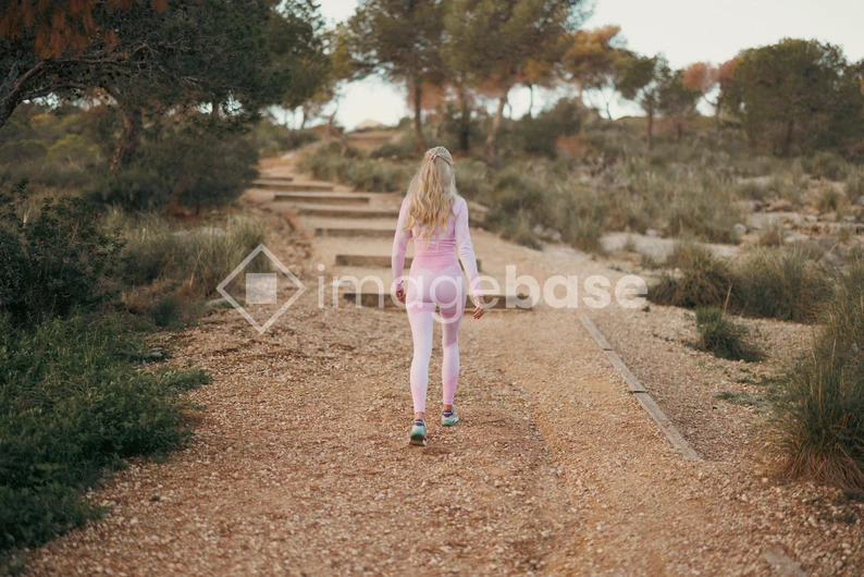 Woman Walking on Trail