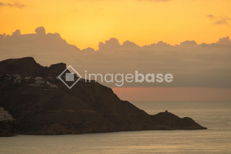 Sunset Over Mountainous Coastline