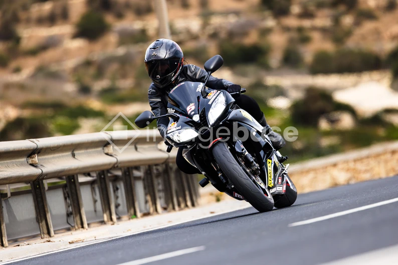 Motorcyclist on a Curvy Road