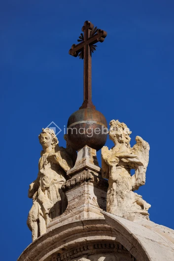 Ornate Cross and Sculptures atop Building