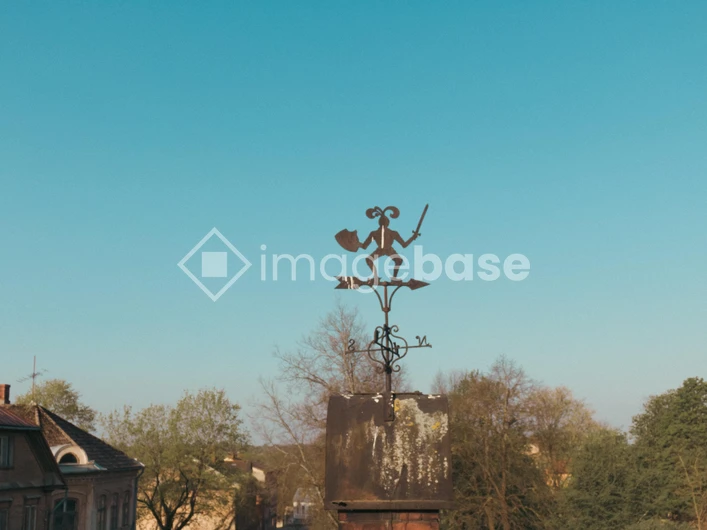 Quaint Weathervane Over Rooftop