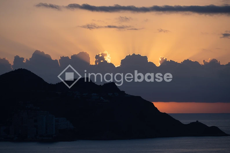 Sunset Over Silhouetted Hills