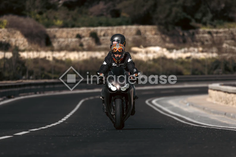Motorcyclist on a Curved Road