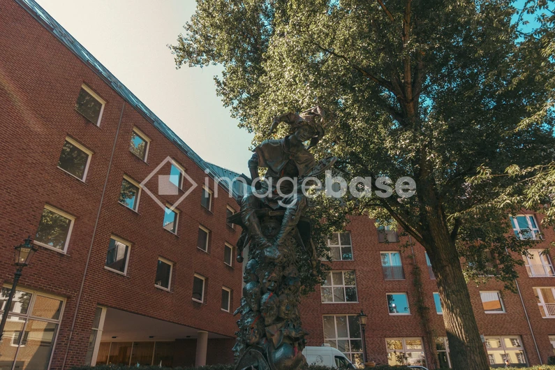 Urban Statue amidst Brick Buildings