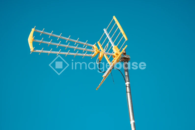 Yellow Antenna Against Blue Sky