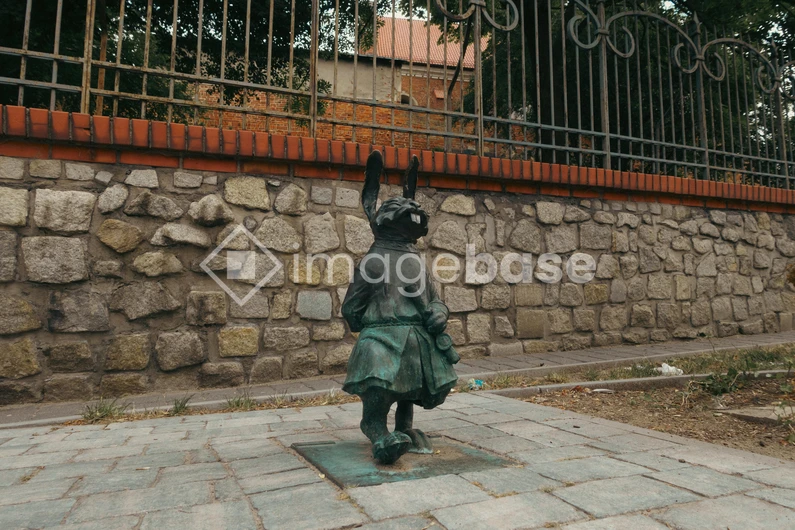 Statue Against Stone Wall
