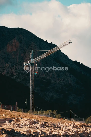 Construction Crane in Mountain Landscape