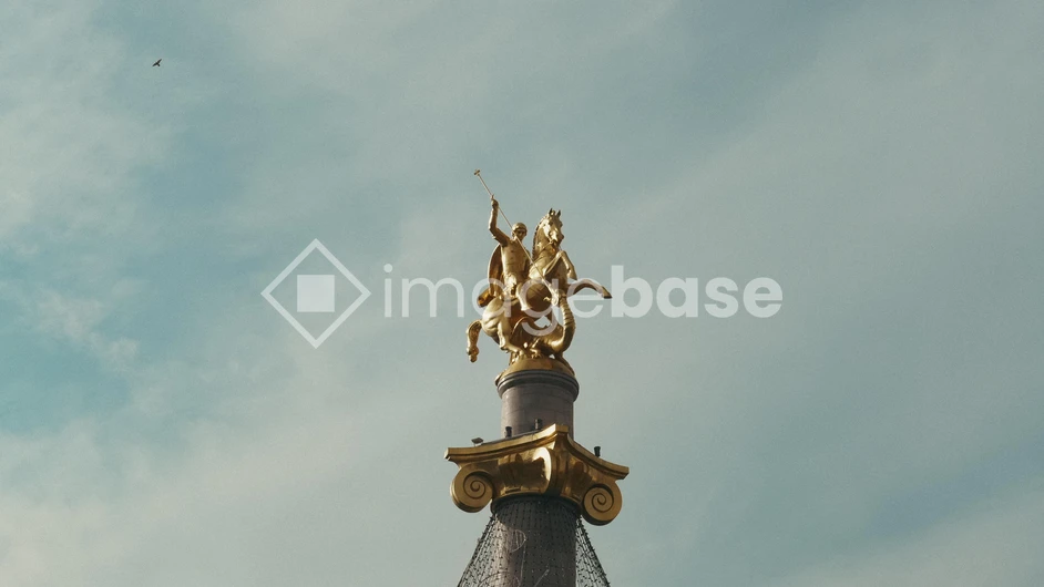 Golden Statue on Pedestal