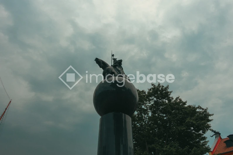 Statue Against Cloudy Sky