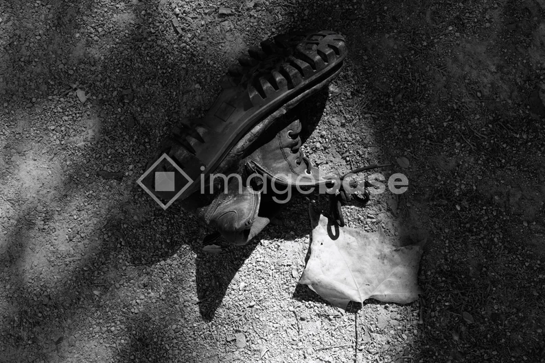 Abandoned Boots in Shadow