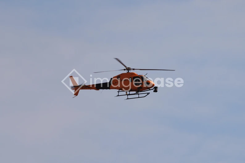 Orange Helicopter in Flight