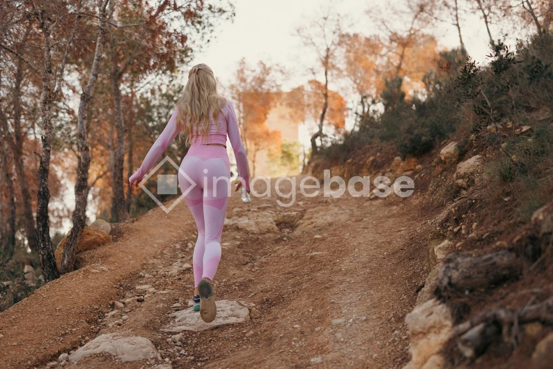 Woman Jogging on Forest Trail