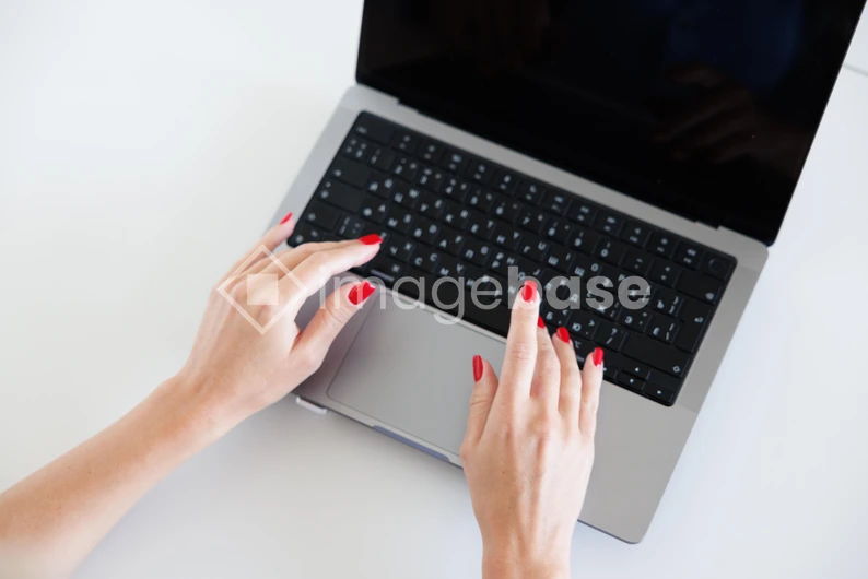 Hands Typing on Laptop