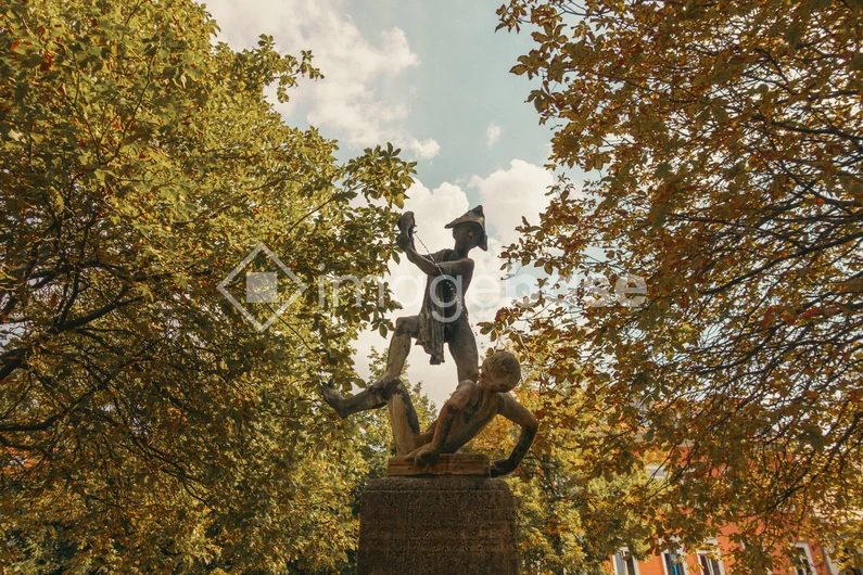 Statue in a Leafy Park