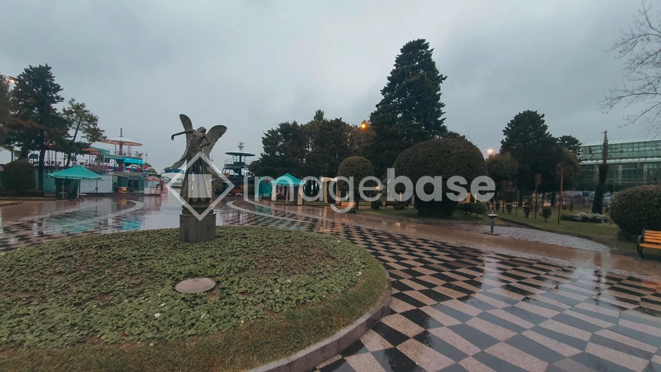Rainy Park Scene with Monument