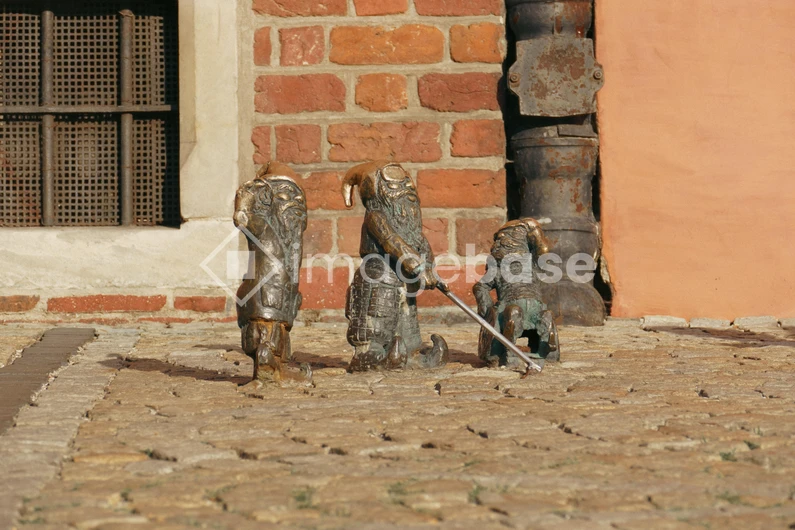 Charming Dwarf Statues on Cobblestone Street