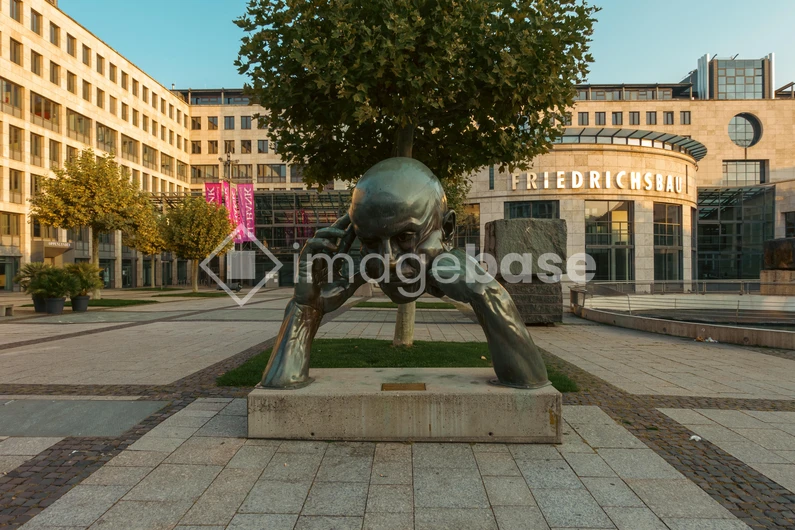 Contemplative Sculpture in Urban Plaza