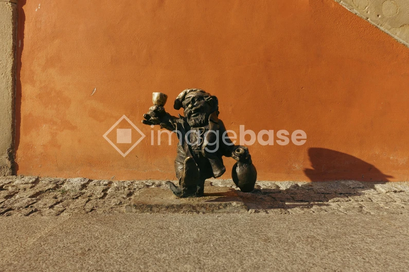 Dwarf Statue Against a Vibrant Wall