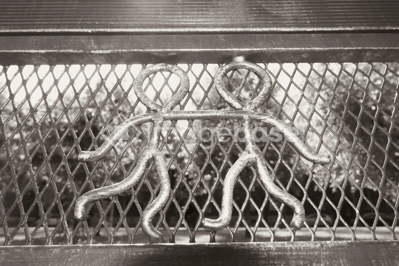 Metal Figures on a Fence