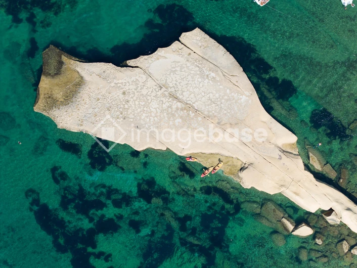 Aerial View of Rock Formation in Crystal Clear Waters