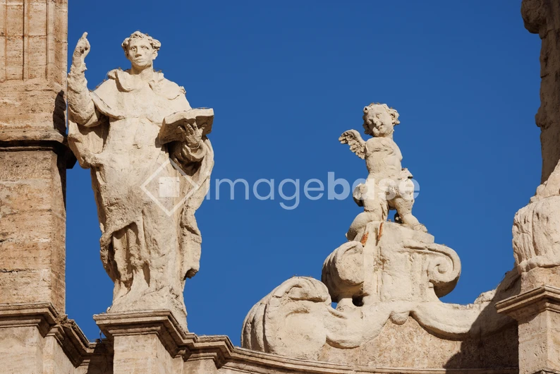 Classical Stone Statues Against Blue Sky