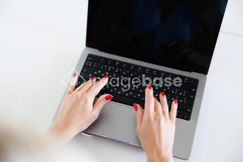 Hands Typing on Laptop