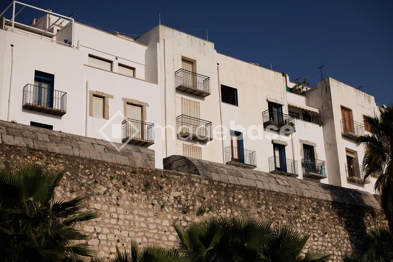 Mediterranean Building and Stone Wall