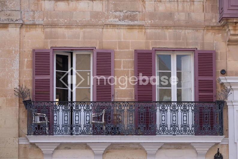 Charming Balcony with Purple Shutters