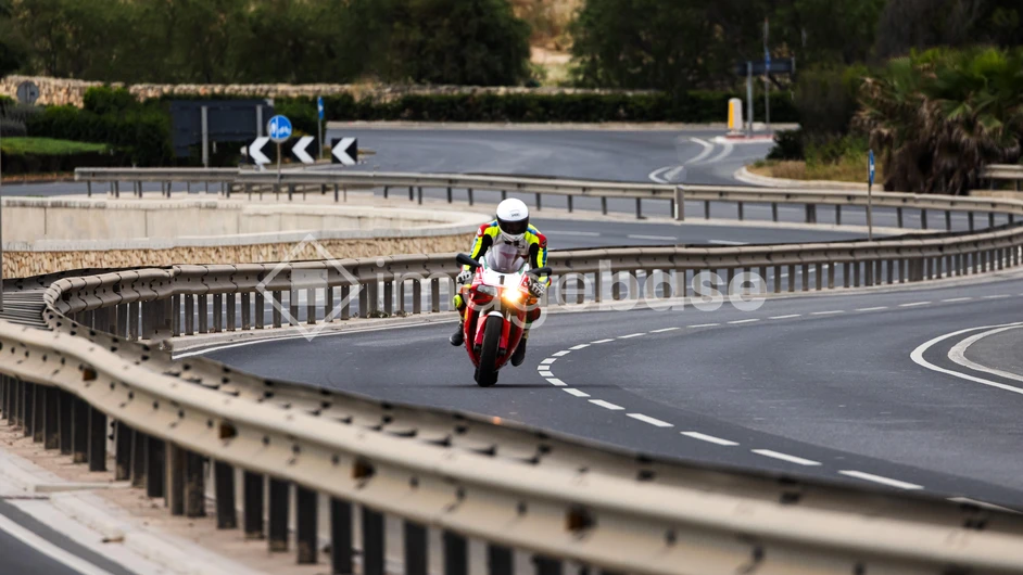 Motorcyclist on a Winding Road