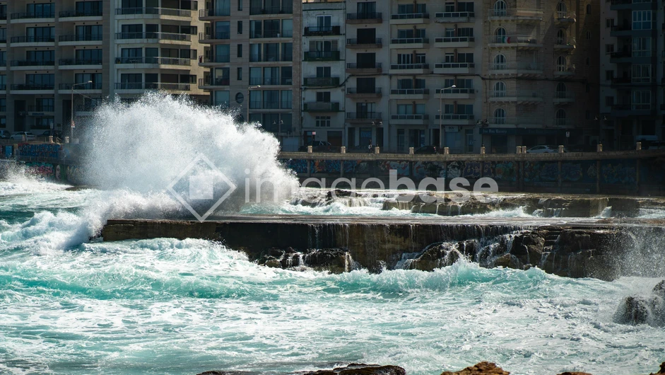 Waves Crashing Against Urban Coast
