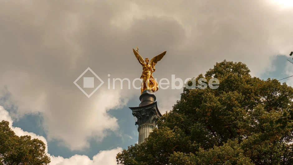 Golden Statue against Cloudy Sky