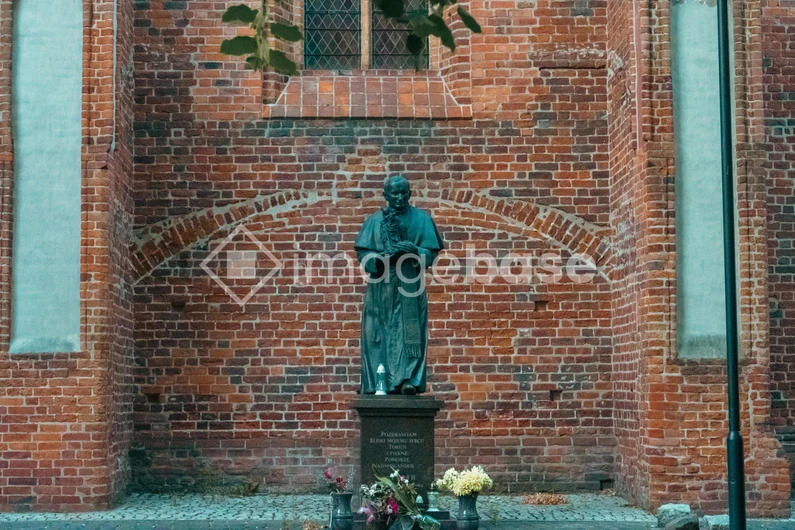 Historic Statue Against Brick Wall