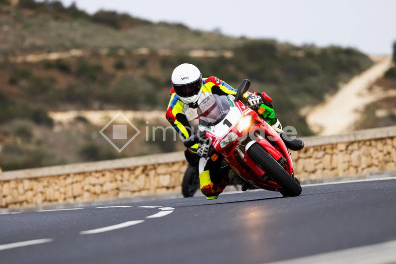 Motorcycle Racing on a Scenic Road